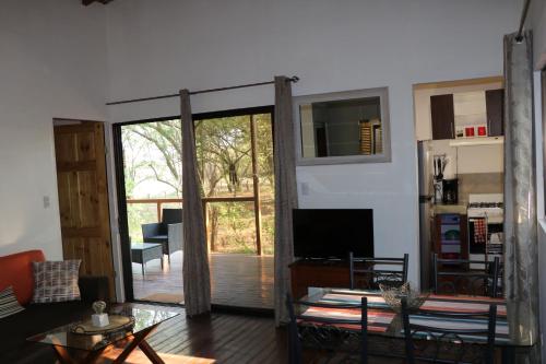 a living room with a sliding glass door leading to a patio at CASA NATURaL in Brasilito