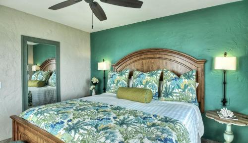 a bedroom with a large bed with a blue wall at Beachcomber Inn in San Clemente
