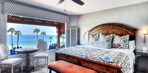 a bedroom with a bed and a view of the ocean at Beachcomber Inn in San Clemente