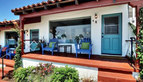 a patio with blue chairs and a table on a house at Beachcomber Inn in San Clemente