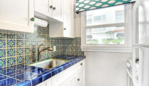 a kitchen with a sink and a window at Beachcomber Inn in San Clemente