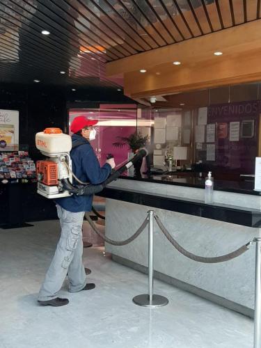 a man standing at a counter in a store at WeEnjoy Hotels Grand Prix Aeropuerto CDMX in Mexico City