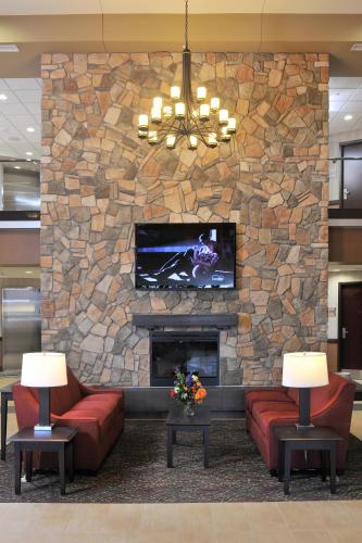 a lobby with a stone fireplace with a tv at Lakeside Hotel Casino in Osceola
