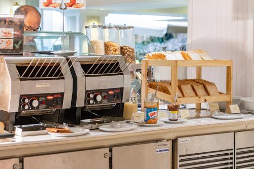 a bakery counter with bread and other food items at Dusit Thani Pattaya in Pattaya North