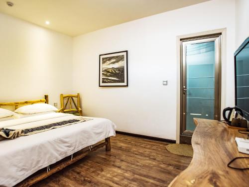 Cama o camas de una habitación en Dunhuang Silk Yododo Inn