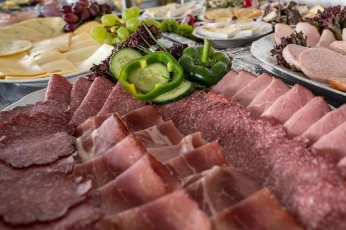 a table full of different types of meats and cheese at Schlei Hotel in Kappeln