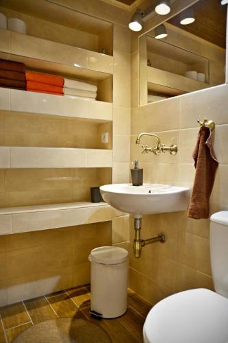a bathroom with a sink and a toilet and a tub at Vinný sklep in Moravská Nová Ves