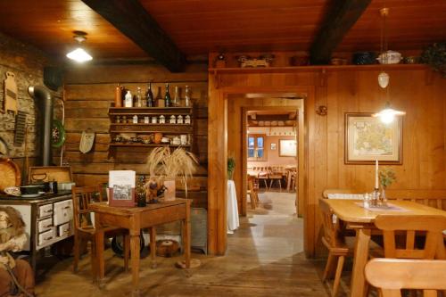 a kitchen with wooden walls and a table and chairs at Das Waldlerhaus in Lam