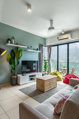 a living room with a couch and a table at The Tropic@Midhill Genting (Free Wi-Fi) in Genting Highlands