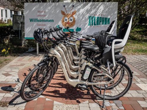 a group of bikes parked in front of a sign at Hotel Xylophon - inklusive Thermeneintritte in Lutzmannsburg