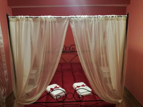 a bedroom with a bed with white curtains at Nel verde di Carinci in Castelpetroso