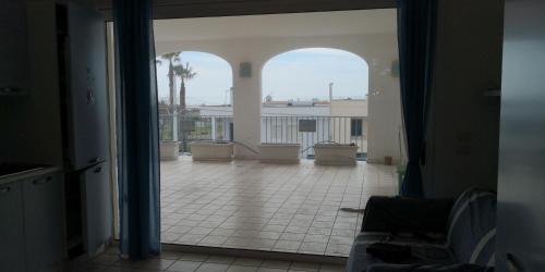 an open door to a large room with a patio at Le sorgenti camere e appartamenti in Torre Vado