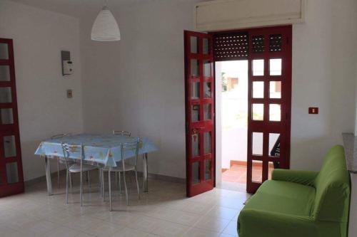a dining room with a blue table and green chairs at Le sorgenti camere e appartamenti in Torre Vado