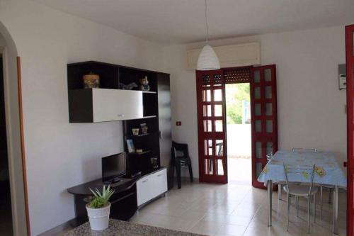 a living room with a table and a dining room at Le sorgenti camere e appartamenti in Torre Vado