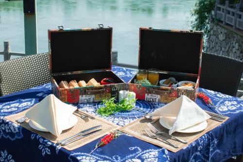 a table with two open containers of food on it at Banyan Tree Yangshuo in Yangshuo
