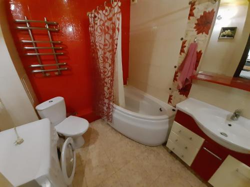 uma casa de banho com um WC, uma banheira e um lavatório. em Трёхкомнатные апартаменты em Krivoy Rog