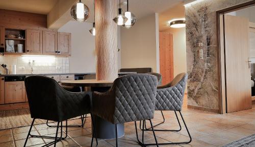 a kitchen with a table and chairs in it at Montana Hochfügen in Hochfugen