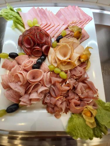 a plate of food with meat and vegetables on it at Hotel Montana Limburg in Limburg an der Lahn