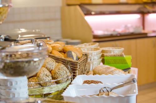 a bunch of baskets of pastries on a table at Hotel Montana Limburg in Limburg an der Lahn