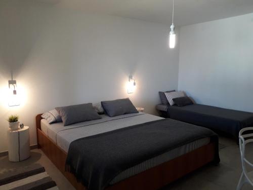a bedroom with a large bed and a couch at ZARA APARTMENT in Banjole