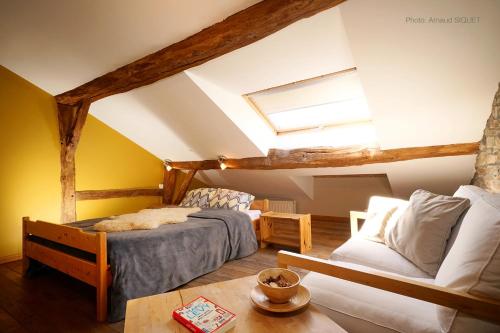 a attic bedroom with two beds and a window at ferme st martin in Manhay