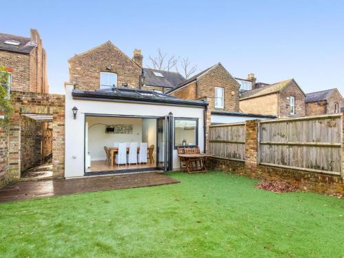 an extension to a house with a backyard at Charming Victorian House w Parking River Walks - Pass the Keys in Windsor