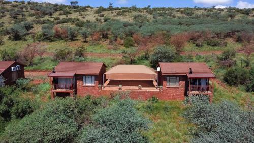 an aerial view of a brick house with a roof at Red Sands Country Lodge in Kuruman