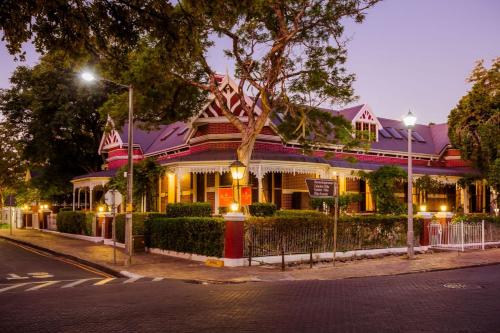 a large house on a street at night at Roosenwijn Guesthouse in Stellenbosch