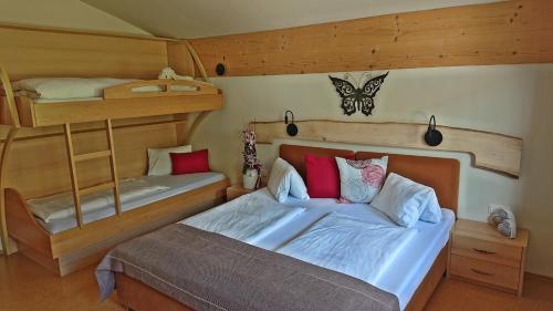 a bedroom with two bunk beds and a bed at Apartment Prossegger in Neukirchen am Großvenediger