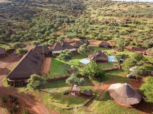 an aerial view of a village with a group of huts at Red Sands Country Lodge in Kuruman