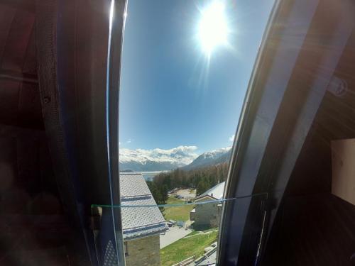 a view of the mountains from the window of a room at Sternwarte by Randolins in St. Moritz