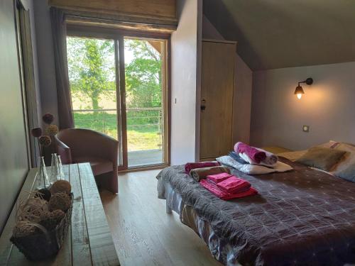 - une chambre avec un lit et une grande fenêtre dans l'établissement Coeur du Finistère, à Pleyben