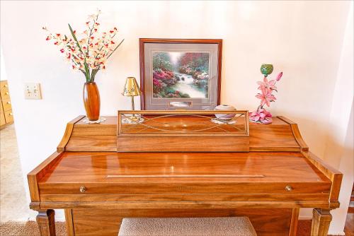 a wooden table with a mirror and a vase with flowers at Linger Longer Lakeside Cottage in Oroville