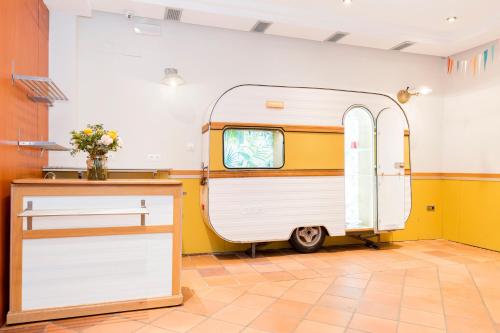 an rv parked in a room with a table at Hotel Sauce in Zaragoza