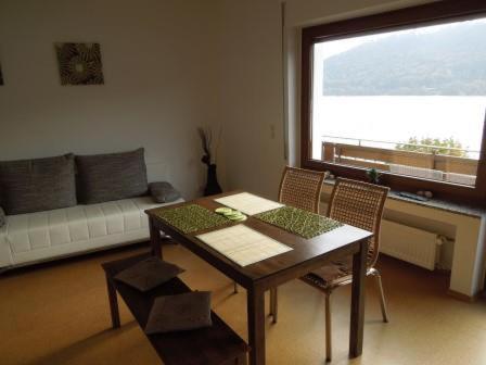 a living room with a table and chairs and a couch at Weingut Theodor Nies in Lorchhausen