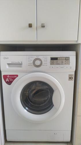 a white washing machine sitting in a kitchen at Adalena Court in Paralimni