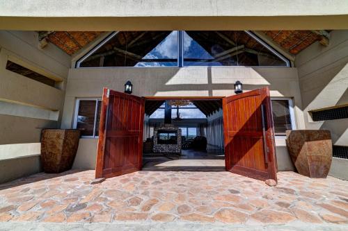 an open door of a house with a stone floor at Naankuse Lodge in Windhoek