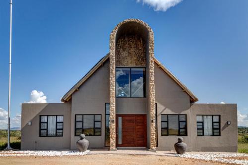 a church with a large door and an arch at Naankuse Lodge in Windhoek