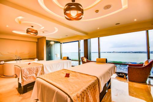 two beds in a room with a view of the ocean at Radisson Blu Gorakhpur in Gorakhpur
