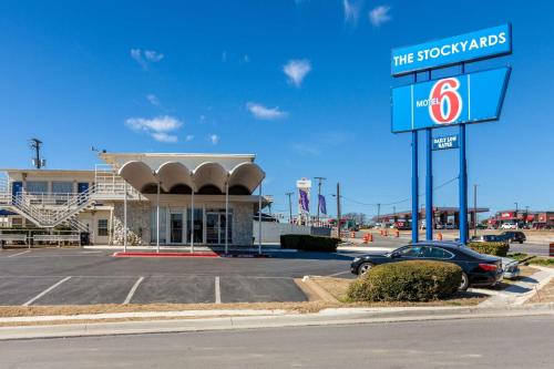 a car parked in a parking lot in front of a store at Motel 6 Fort Worth, Tx - Stockyards in Fort Worth