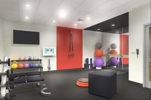 a room with a gym with a flat screen tv at Tru by Hilton Perrysburg Toledo in Rossford