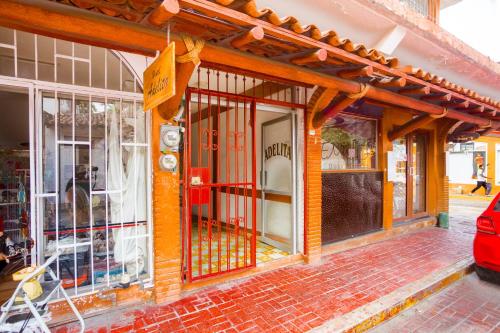 a store front with an iron gate on a building at Hotel Adelita in Zihuatanejo