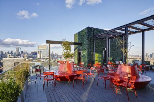 a row of tables with chairs and umbrellas at citizenM New York Bowery in New York
