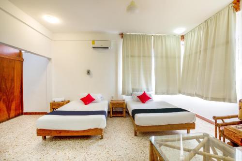 Un pat sau paturi într-o cameră la Hotel Adelita