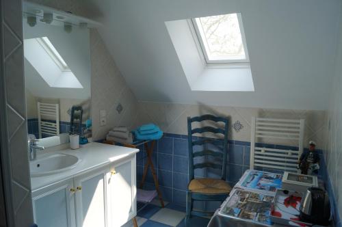 a bathroom with a sink and two skylights at Chambres d'Hôtes La Loubatais in Dol-de-Bretagne