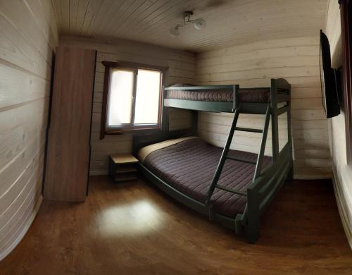 a room with two bunk beds in a cabin at Дворик Софии in Gribovka