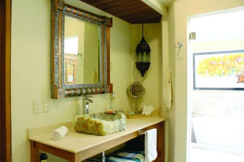 a bathroom with a sink and a mirror at Hotel Lindo Ajijic Bed & Breakfast in Ajijic