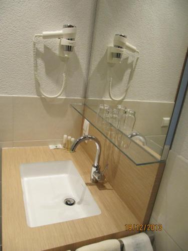 a bathroom with a sink and a glass counter at Gasthaus-Krone-Post in Simonswald