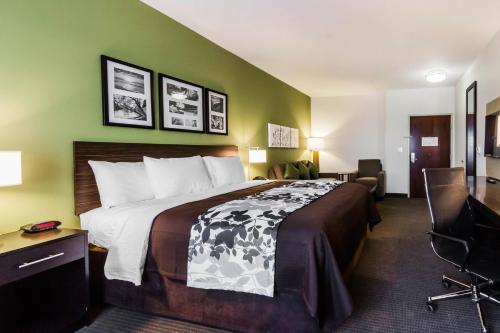 A bed or beds in a room at Sleep Inn & Suites