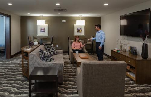 a man and a woman standing in a living room at Staybridge Suites - Phoenix – Biltmore Area by IHG in Phoenix